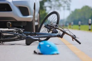 Bike in road hit by car