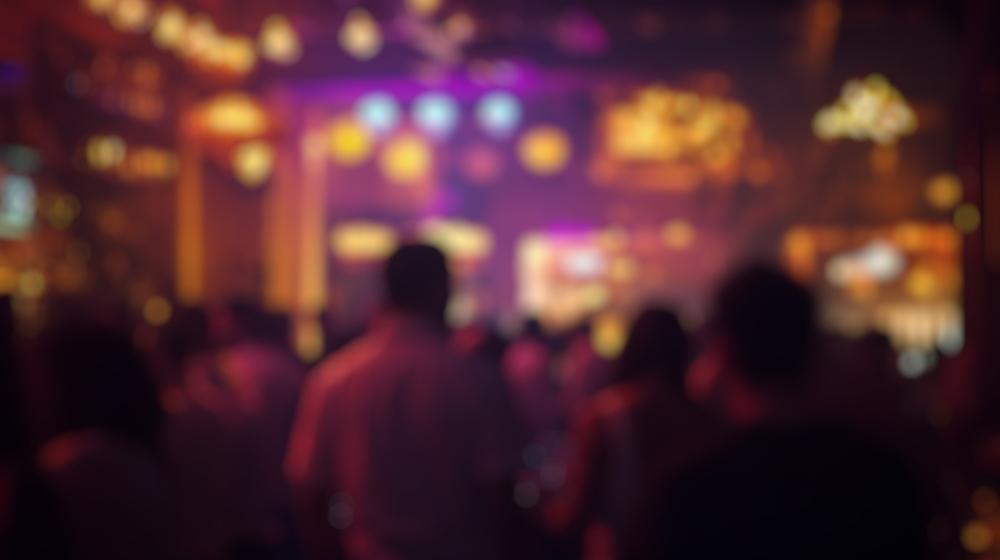 A crowd in a nightclub. A lawyer can explain if you can recover damages in a bar or nightclub shooting.