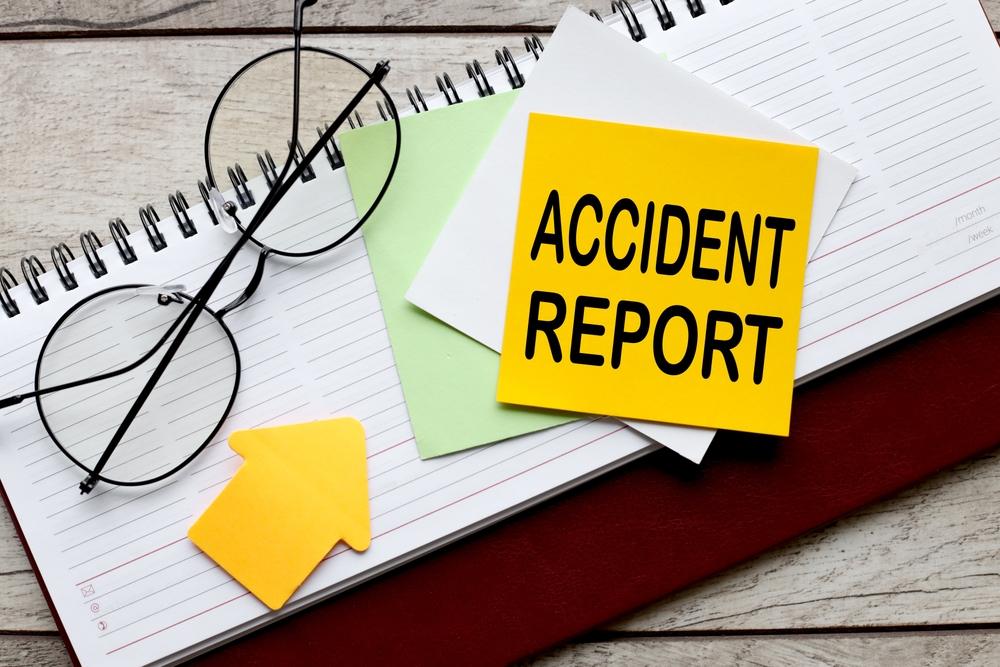 Notepad with “Accident Report” written on it, with someone nearby wondering how to get an accident report in Stamford, Connecticut