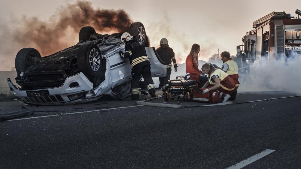First responders near overturned vehicle provide medical treatment after an accident in Stamford.